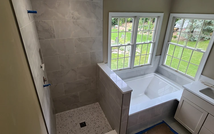 Marble Bath with Garden View — luxury bathroom tile installation by Lotto Custom Tile