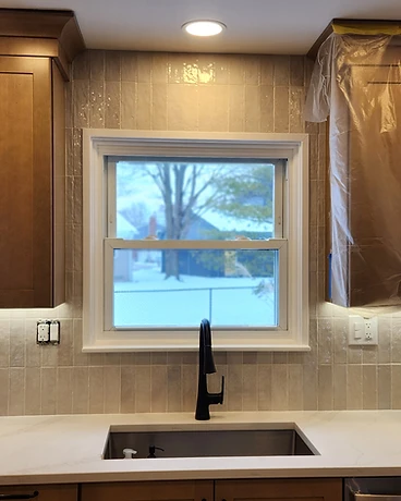 Subway tile kitchen backsplash with matte black fixtures