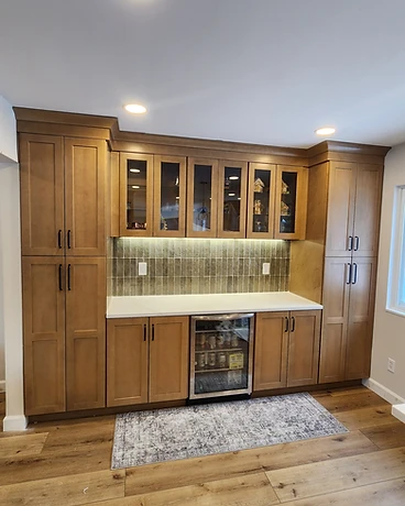 Close view of a mosaic kitchen backsplash with a decorative inset