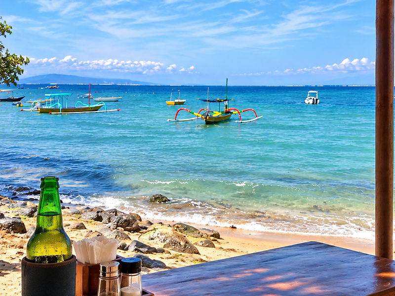 Sanur beachside dining with traditional boats