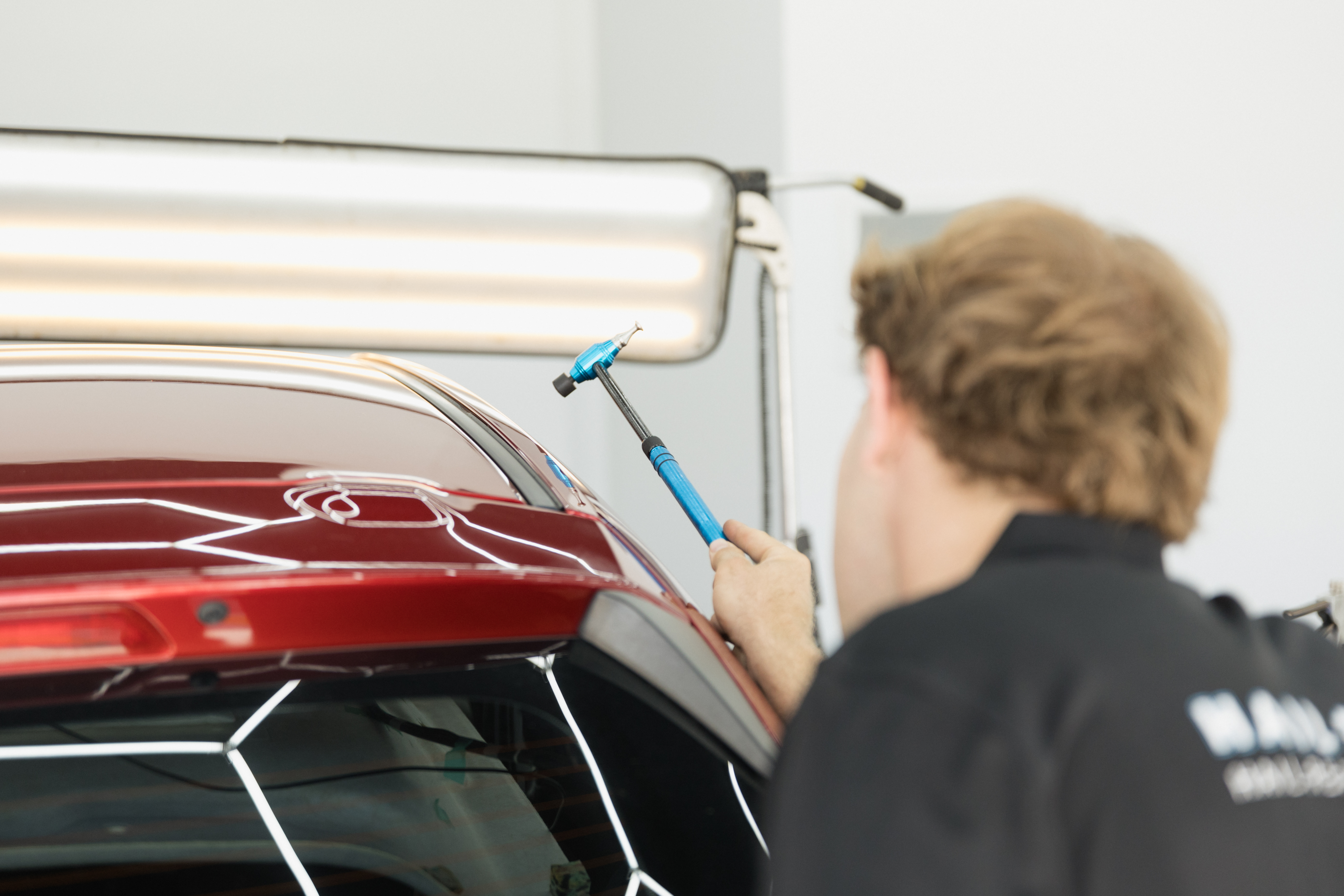 HS Autobody technician performing paintless dent repair