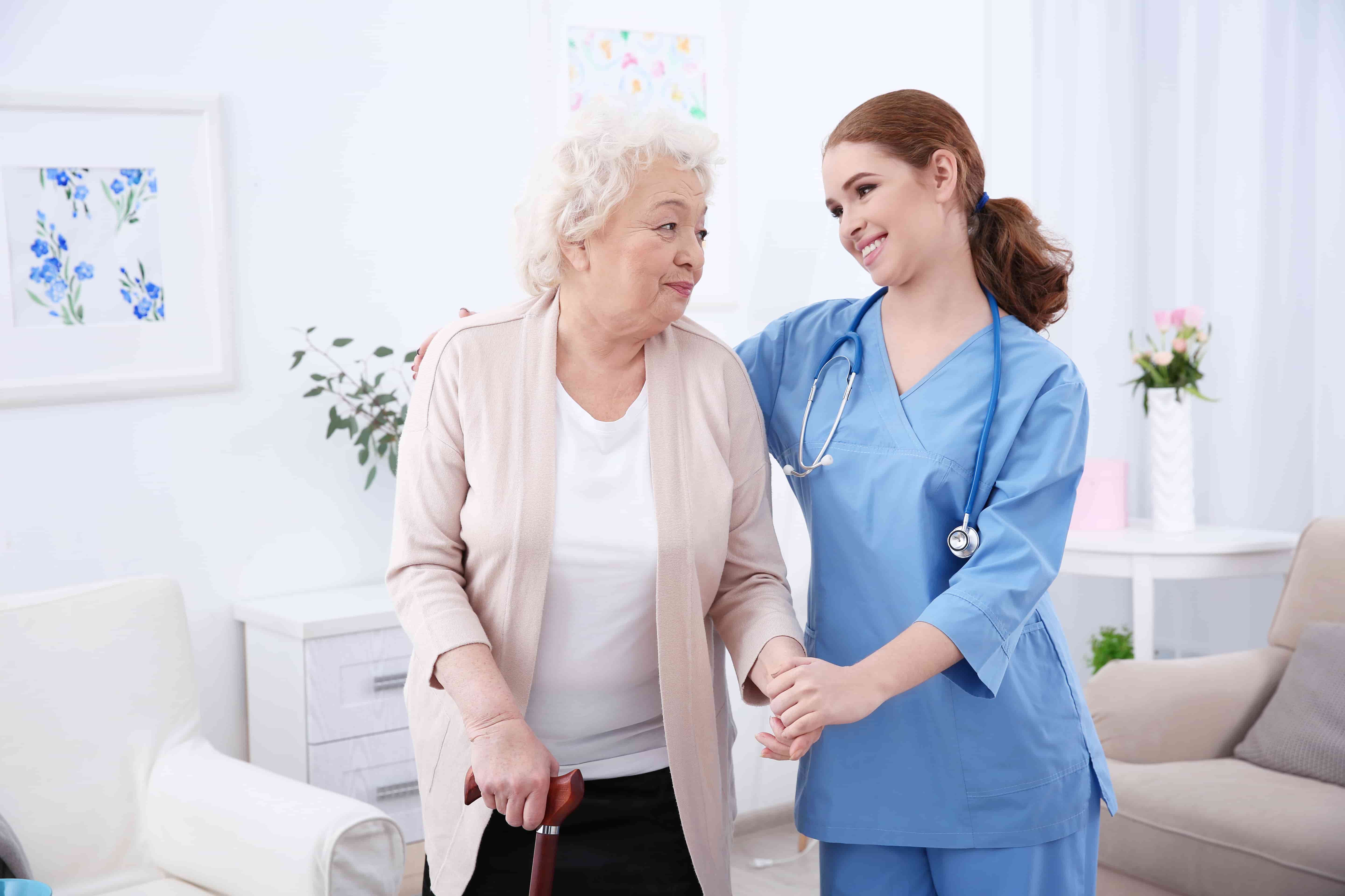 A warm carer supporting an elderly client at home