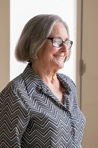 A carer sharing a warm moment with an elderly person at home