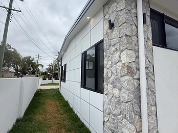 Hamilton St photo 8 — Exterior — white panels with stone masonry feature