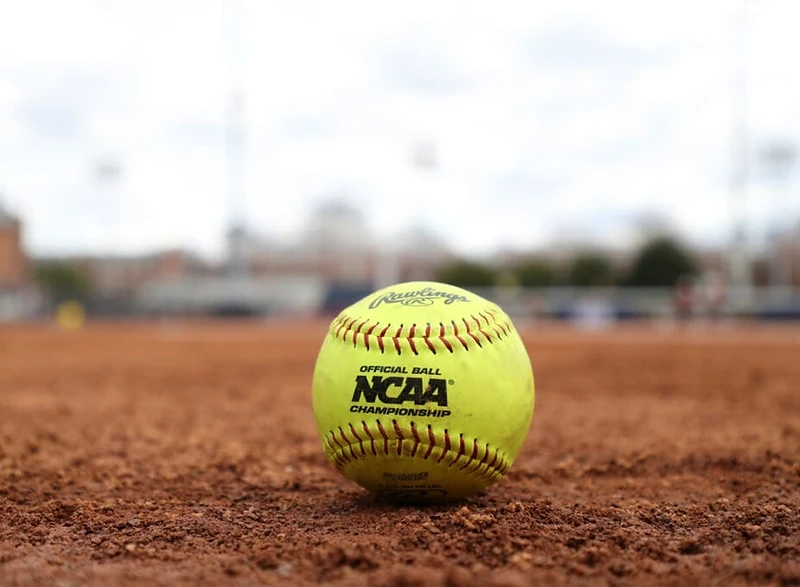Softball resting on infield dirt