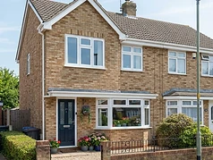 Newly installed white casement window on a British semi-detached home