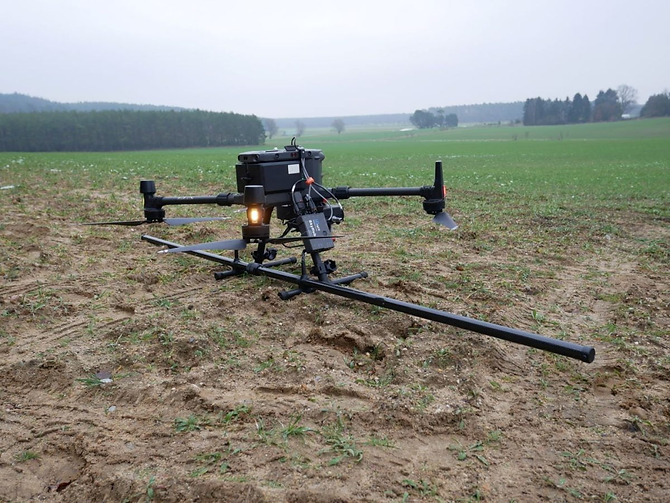 Survey drone with underslung magnetometer sensor for geophysical mapping