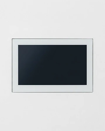 Panel táctil KNX montado en horizontal sobre una pared blanca