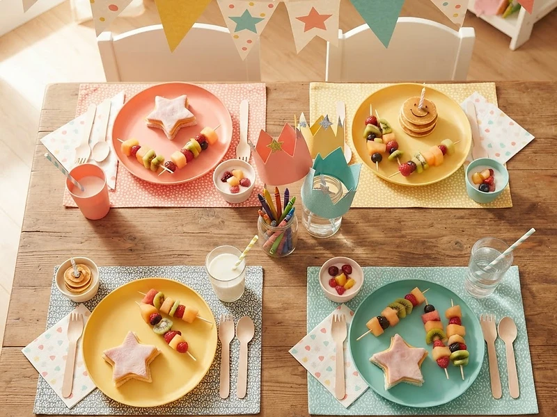An enchanted dinner table lit by candlelight, a gold-rimmed teacup at its center