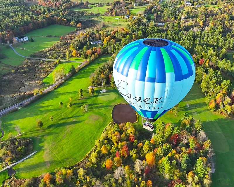 Aerial hot air balloon flight over autumn landscape