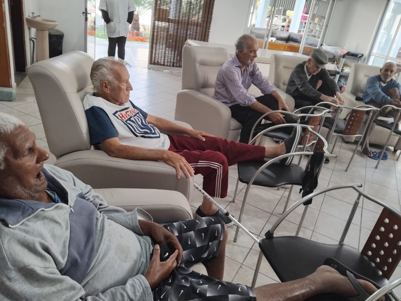 Pessoas idosas conversando no salão de estar da CAIFA