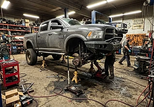 Lifted pickup on jack stands in the shop