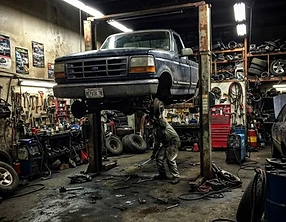 Mobile mechanic working on a truck on site, phone snapshot