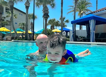 Nate with his child at the pool