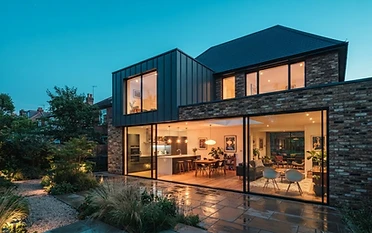 Oakridge Build & Craft homepage — a modern residential extension at dusk in Reading, Berkshire