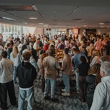 Attendees gathering and connecting between sessions at a past Wave Church event