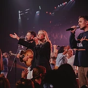 Worship leaders singing with the congregation