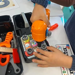 Building with a toy power drill