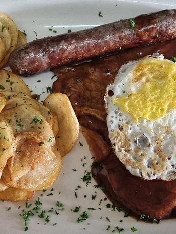 Rump steak with fried egg, boerewors and chips at Ferreira's