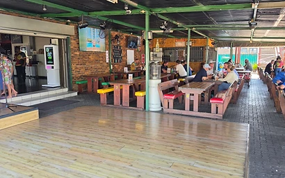 Live musician performing on the patio stage at Ferreira's