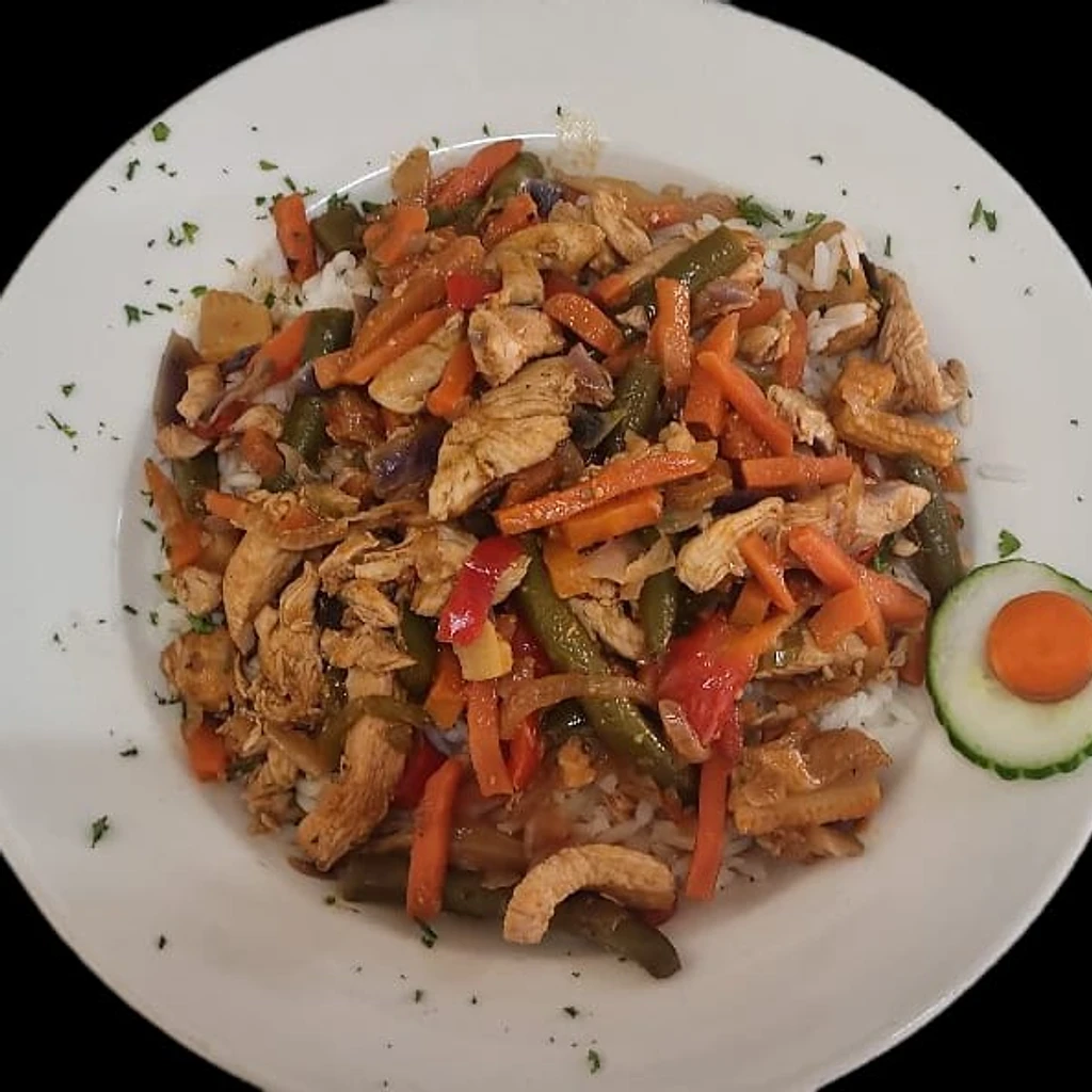 Chicken stir-fry with vegetables over rice at Ferreira's Sports Bar in Boksburg