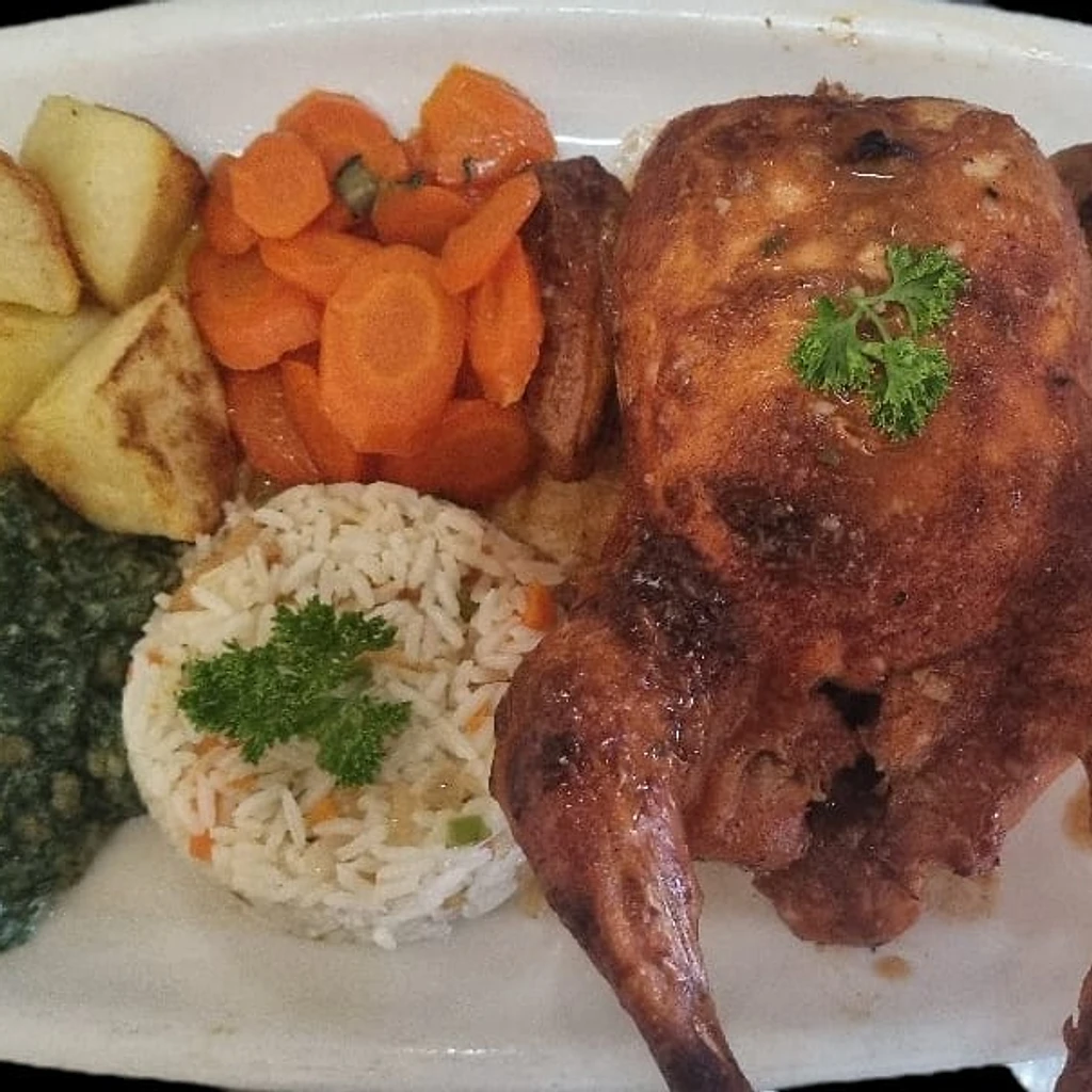 Whole roasted chicken with rice, carrots, spinach and potatoes at Ferreira's Sports Bar in Boksburg
