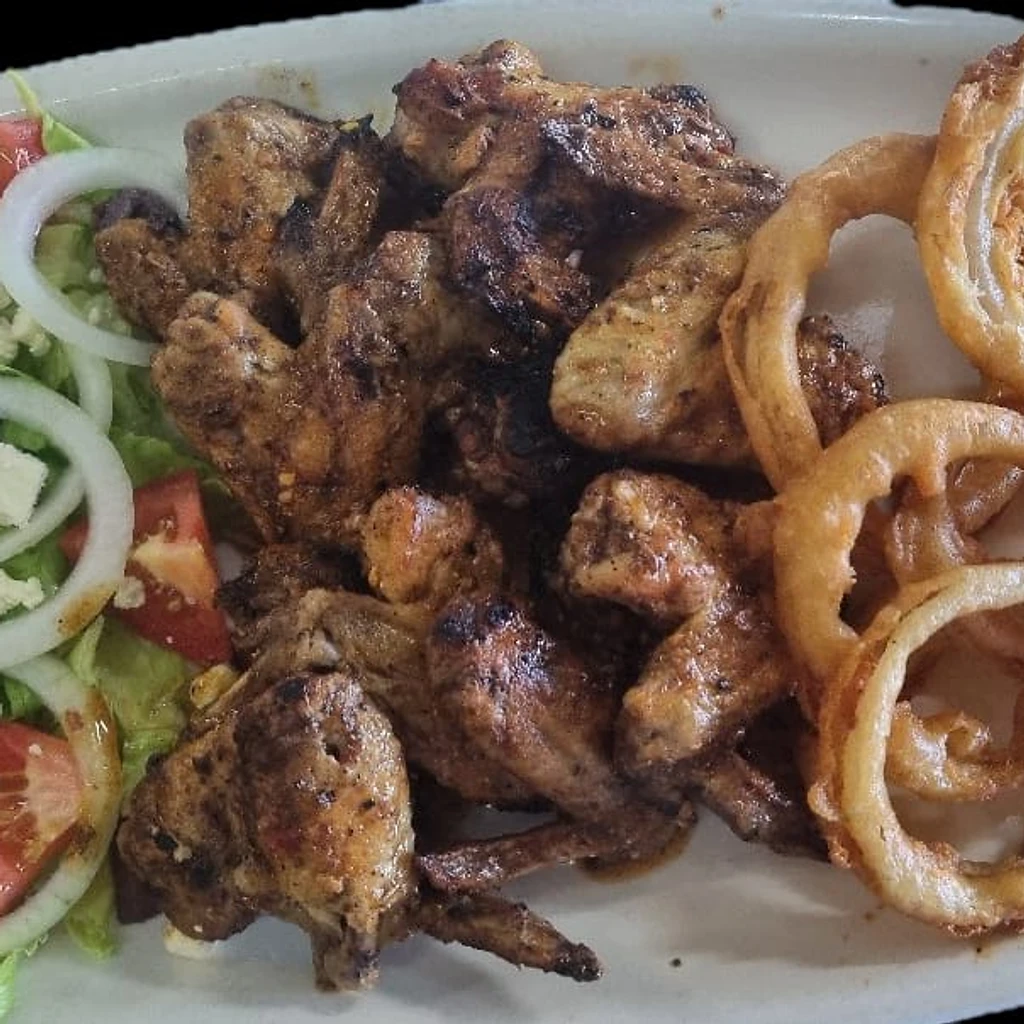 Chicken wings platter with Greek salad and onion rings at Ferreira's Sports Bar in Boksburg