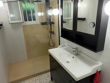 Salle de bain après travaux — finition Mortex minérale, douche à l'italienne