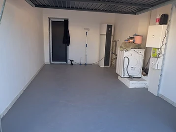Garage avant rénovation — sol béton brut et inégal