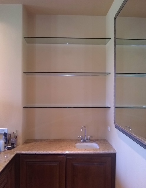 Custom wall mirror with glass shelves and granite counter installed by Holland Glass & Mirror in the Coachella Valley