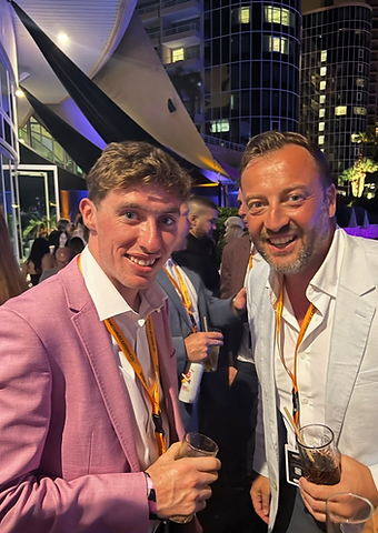 Jack Kennedy in a pink blazer toasting at a Berkeley Red event