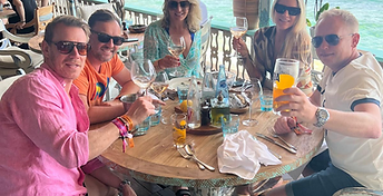 Group toast at a Riviera beach club