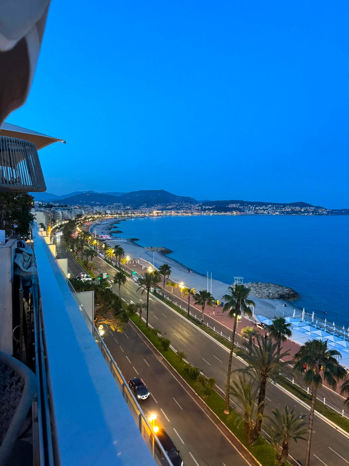 Dusk view over the Riviera promenade and coastline from a private balcony