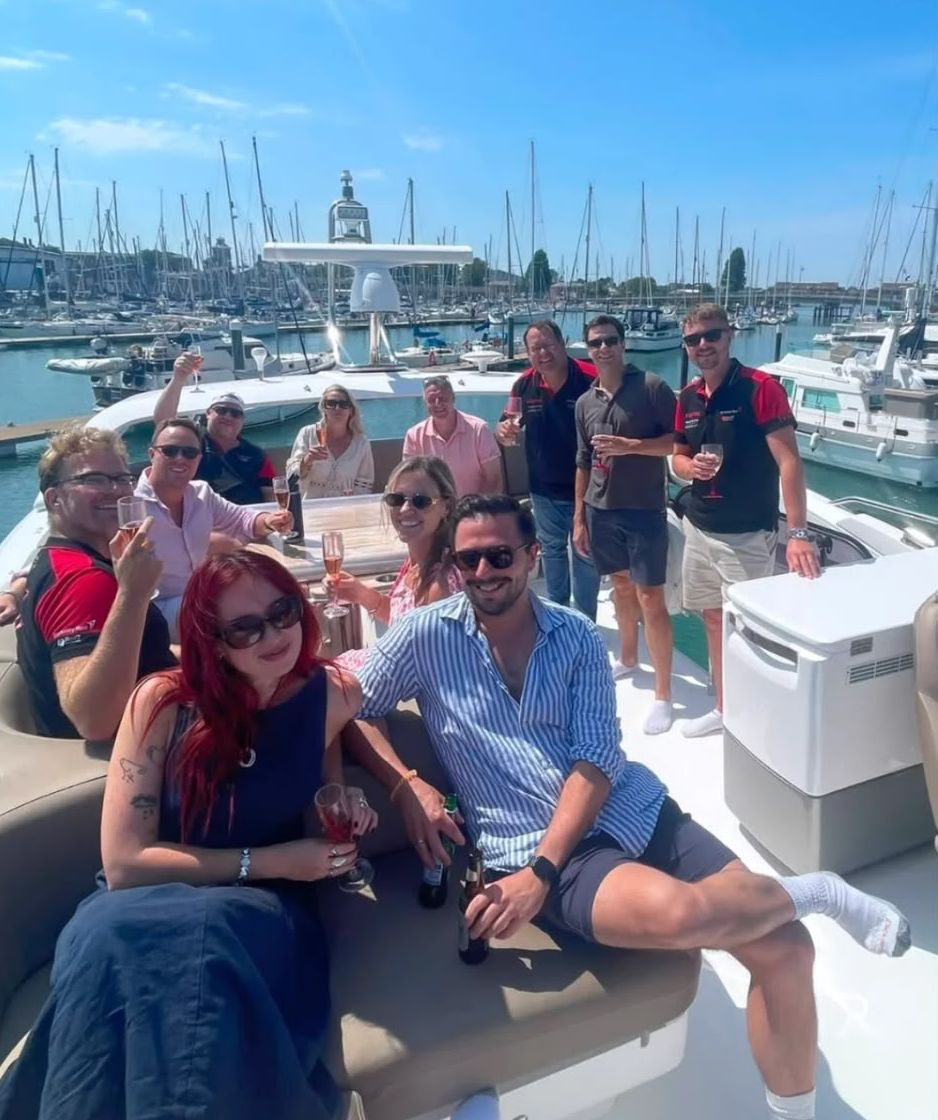Berkeley Red group gathered on a boat in a marina