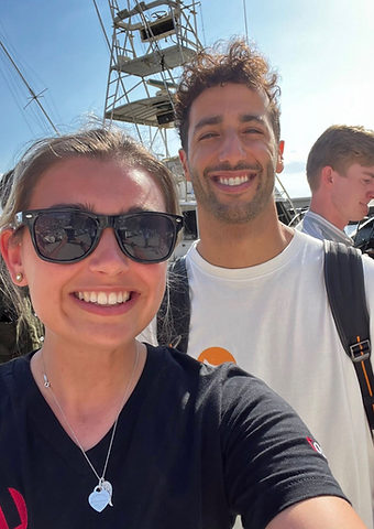 Daniel Ricciardo taking a selfie with a guest aboard a yacht in the Monaco marina