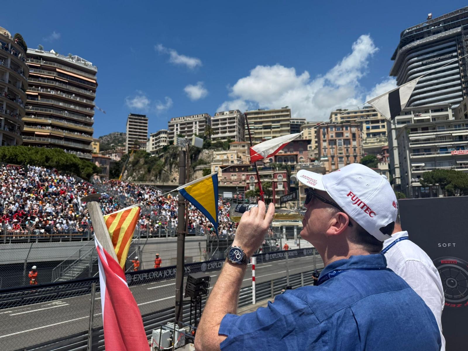 Guest watching the race from a balcony above the grandstand at the Monaco Grand Prix