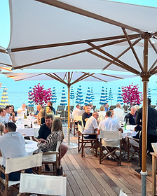 Private beach club dinner as the sun goes down