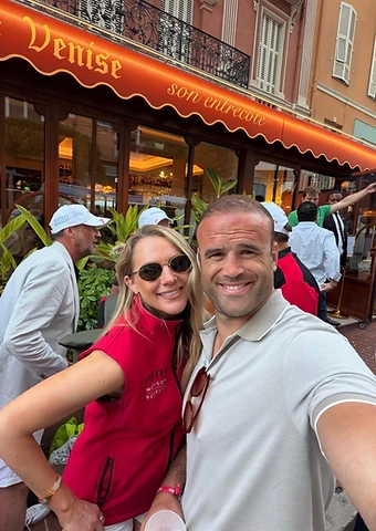 Two guests taking a selfie outside a Riviera restaurant