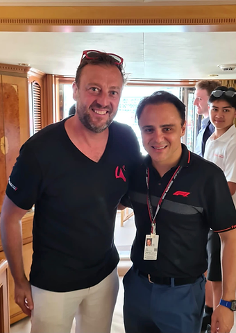 Felipe Massa posing with a Berkeley Red host aboard a yacht in Monaco