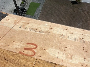 New plywood sheet marked with spray paint number 3