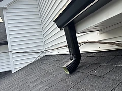 Black Downspout on White Siding