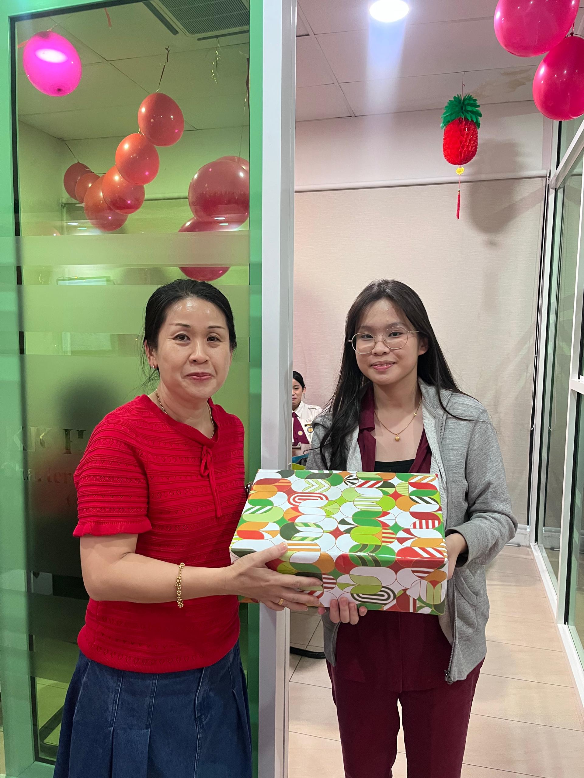 KKHO team celebrating with a gift
