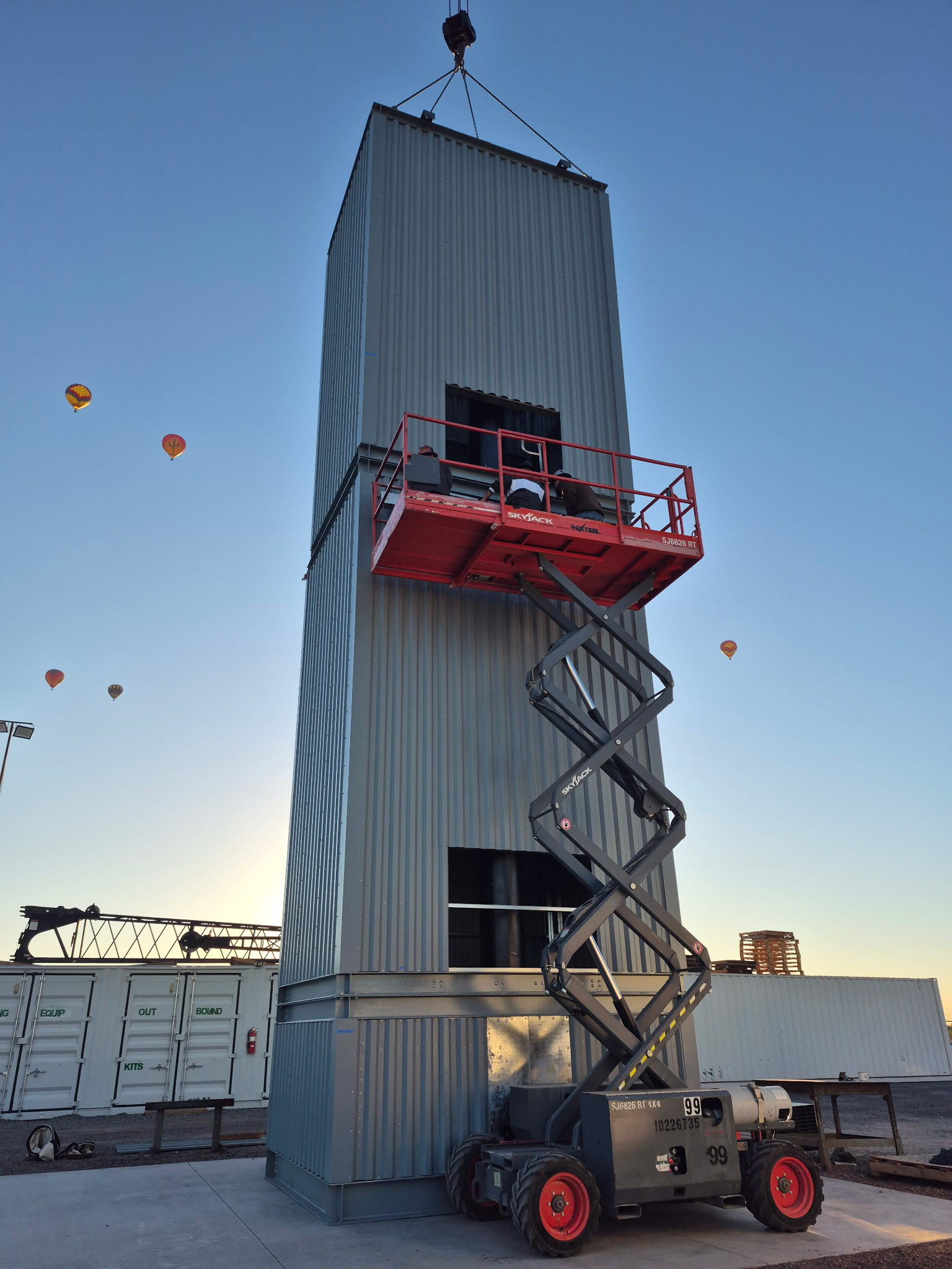 RoXteel plenum tower being assembled on site with a scissor lift