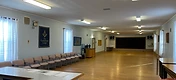 The hall looking down its full length toward the curtained stage