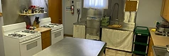 The kitchen with stoves, sink, and prep island