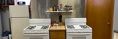 Two gas stoves with spice shelf and refrigerator