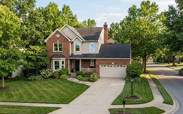 A well kept two storey family home with clean windows on a leafy Columbia Missouri street.