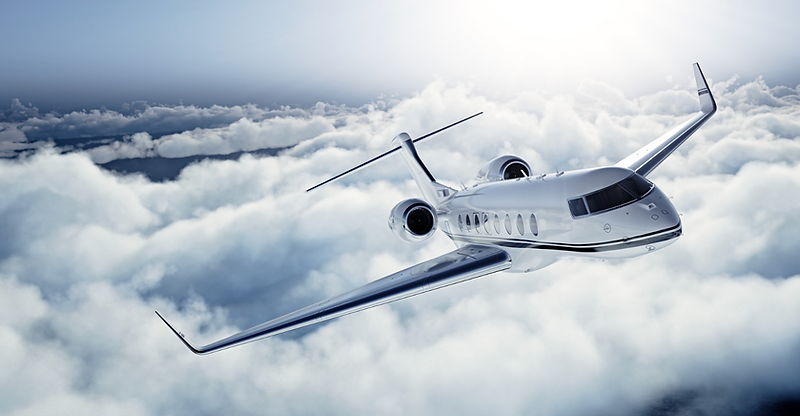 Private jet flying above the clouds