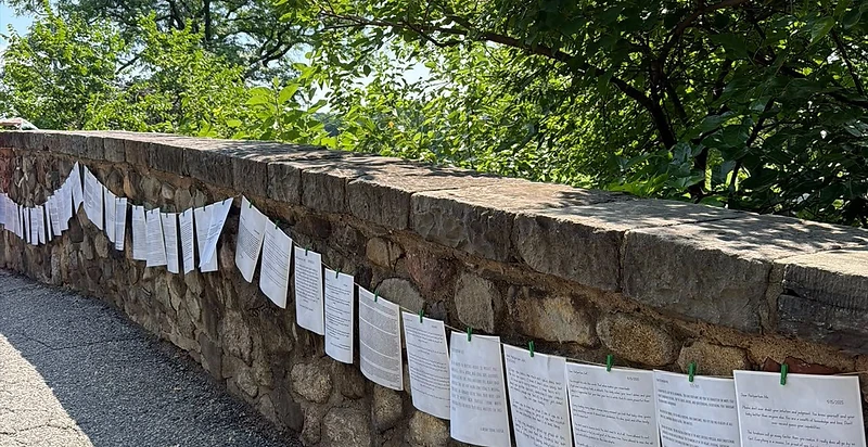 Community letters pinned to a stone wall
