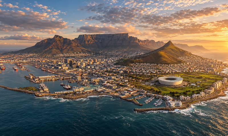 Aerial view of Cape Town at sunset with the V&A Waterfront, Cape Town Stadium and Table Mountain
